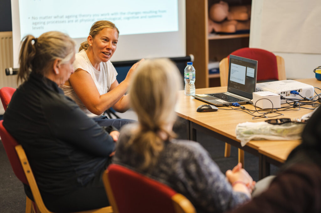 Women at a meeting table talking