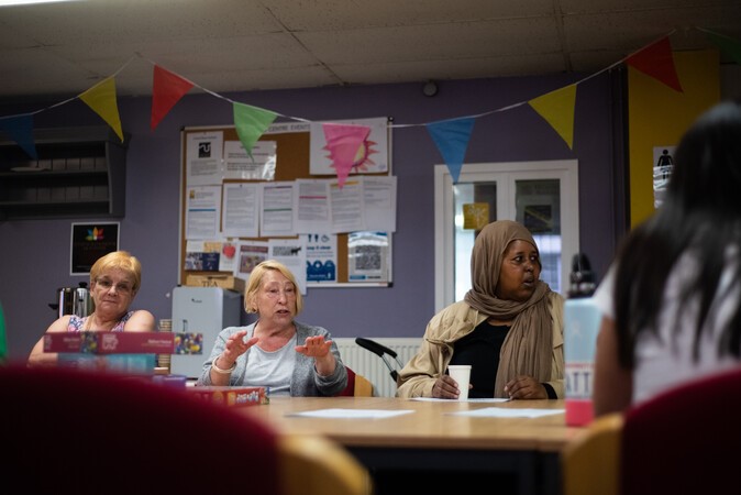 3 women around a meeting table