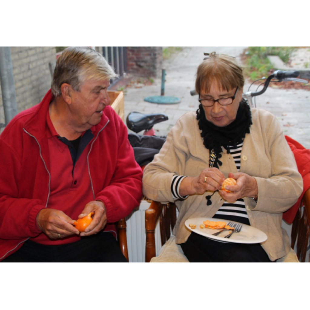 Image of two people eating oranges