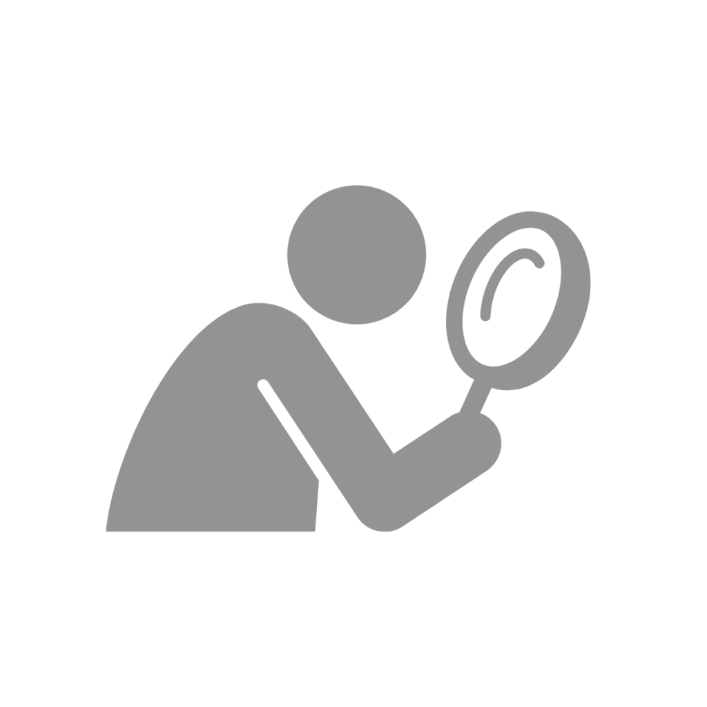 Person looking through a magnifying glass