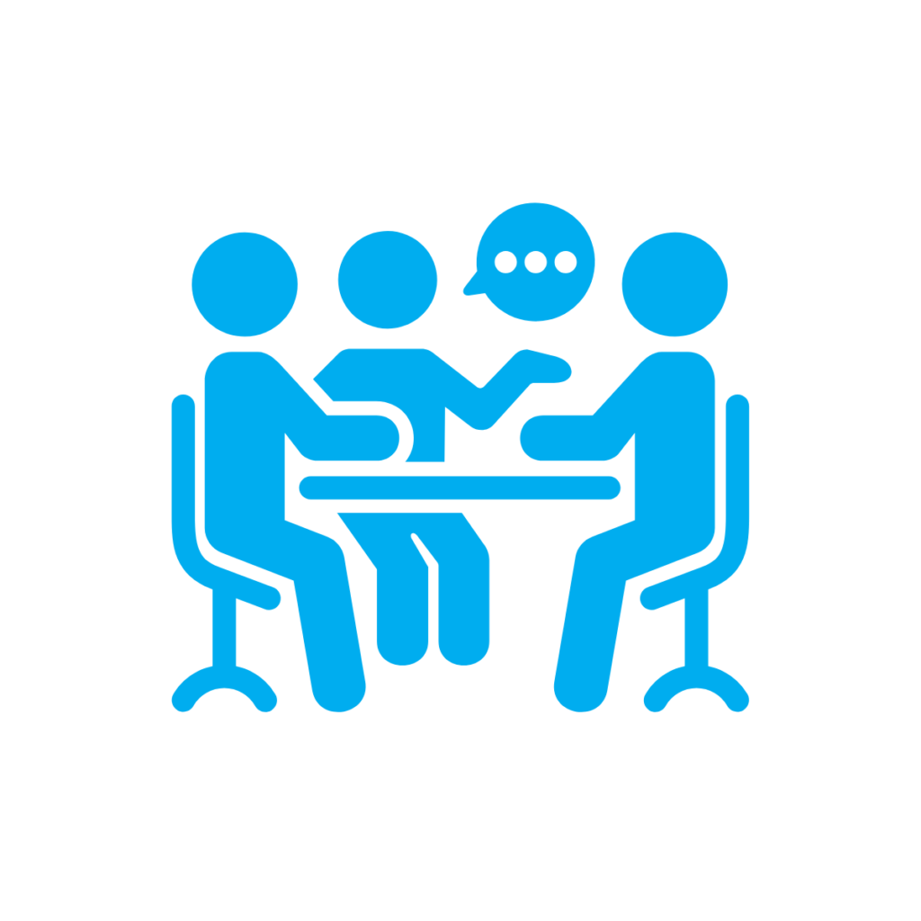 Image of people sat around table discussing