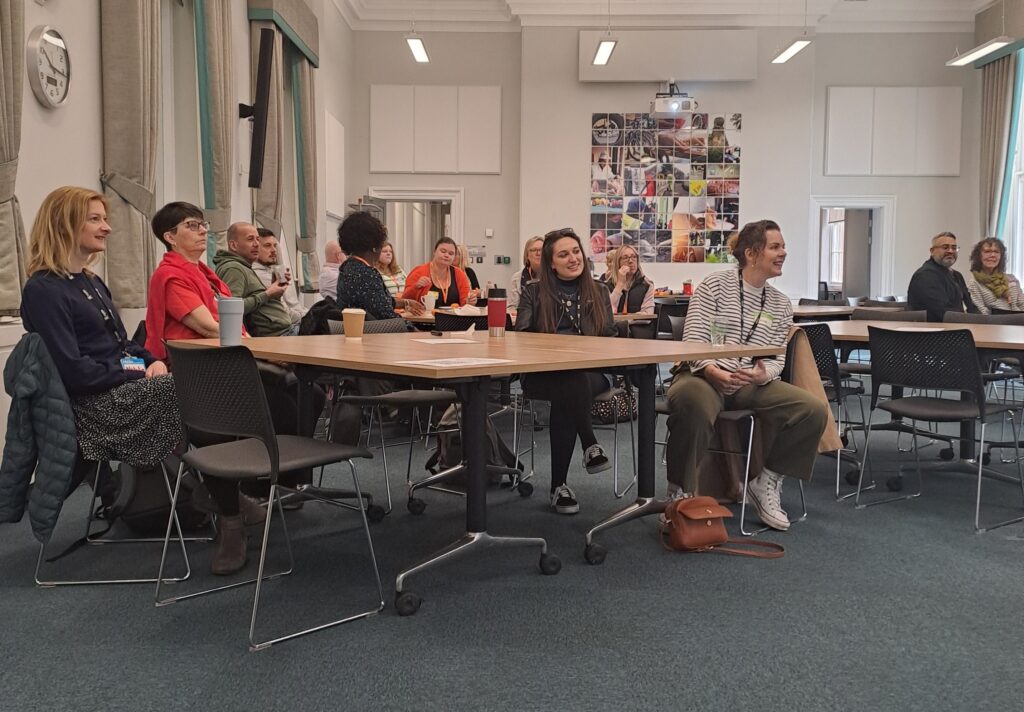 Photo of people sat around tables