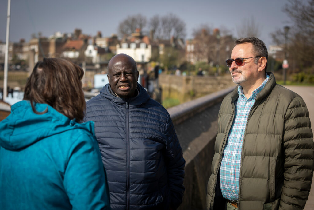 Photo of people stood around chatting