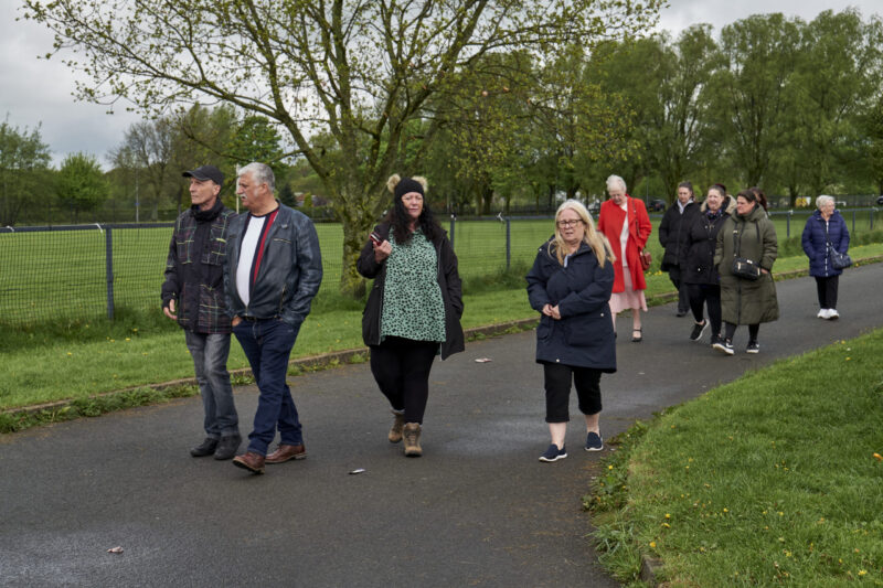 Group of men and women walking through the countryside