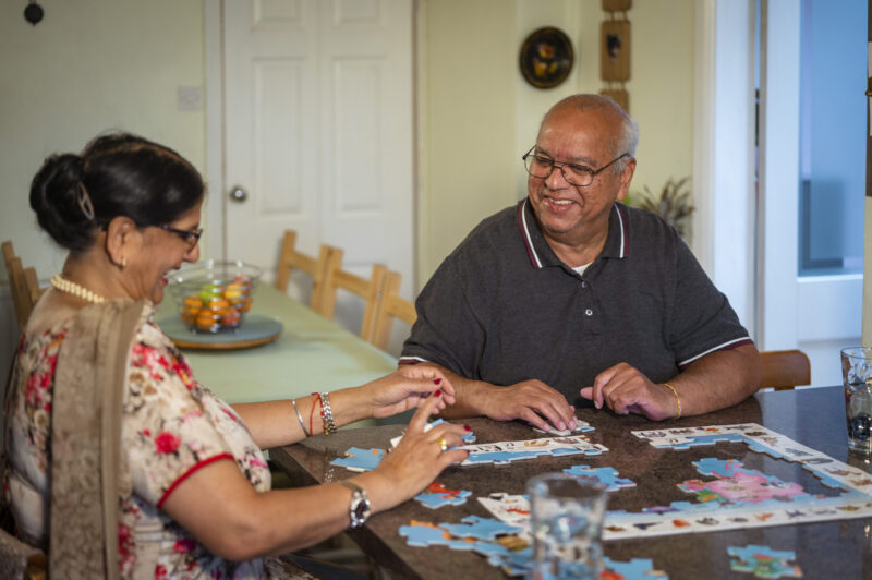 Sikh man and woman completing a jigsaw