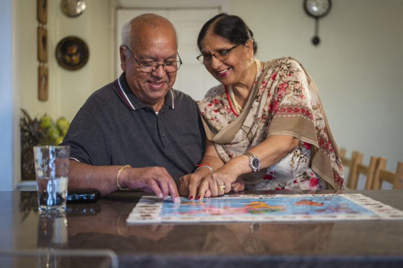 Sikh man and woman completing a jigsaw