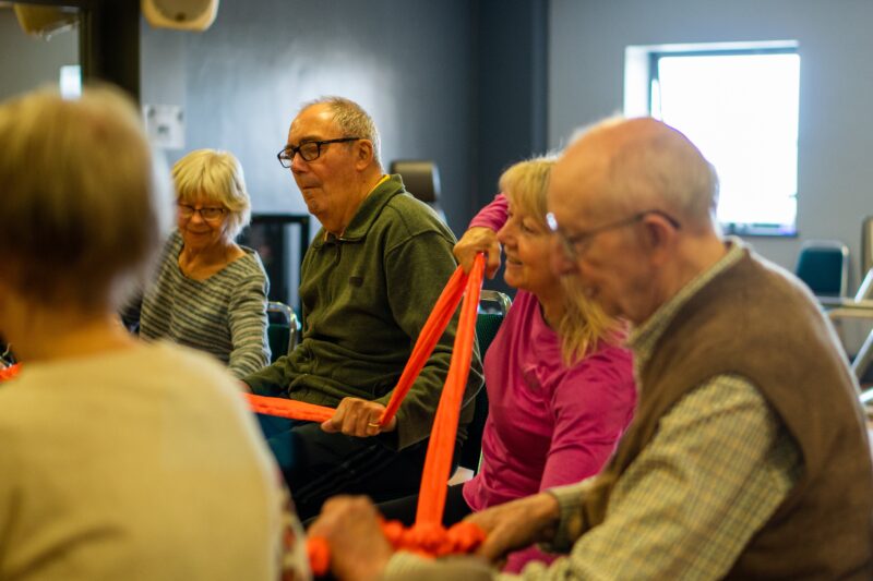 Group of older people with a ribbon