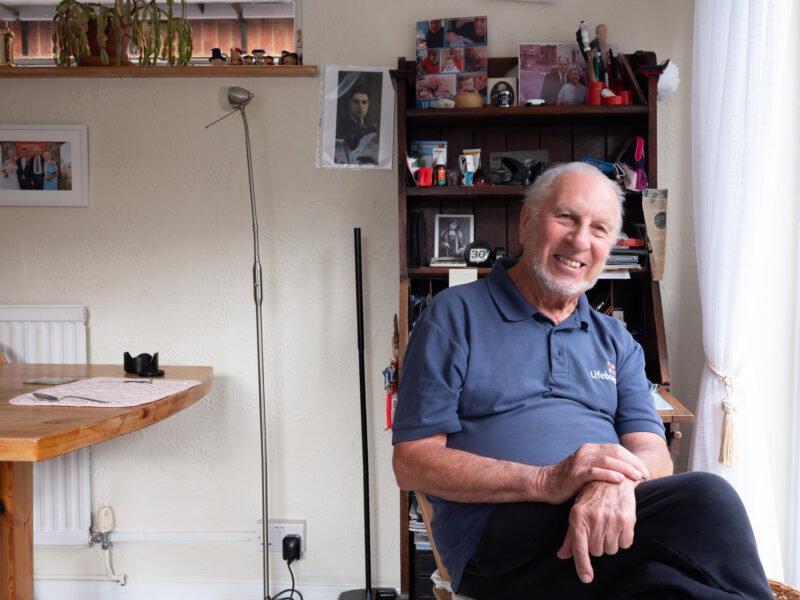 Man sat smiling in chair