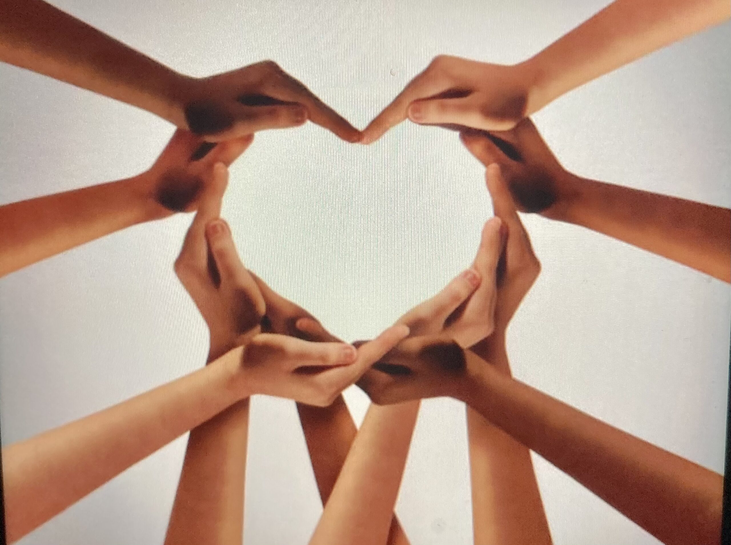 image of hands in a circle, making a heart shape