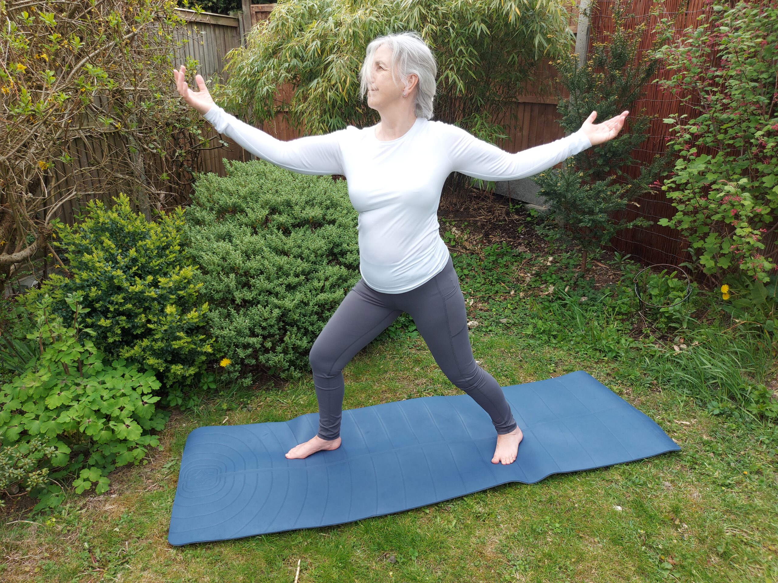 Debbie the yoga teacher illustrating Warrior Pose