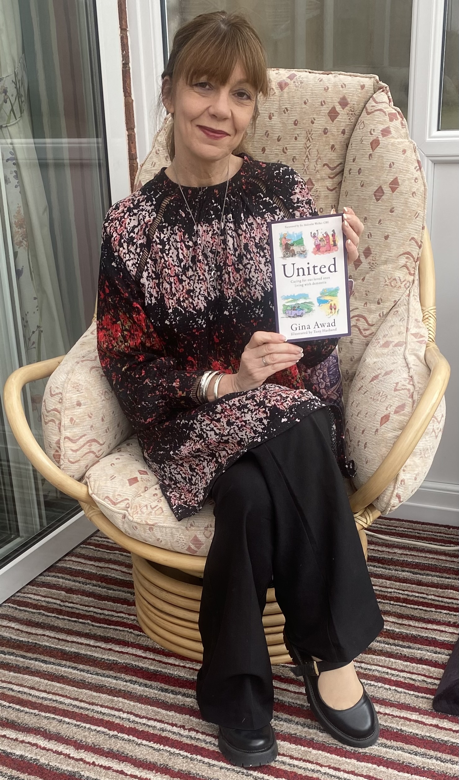 Person sat on chair holding leaflet