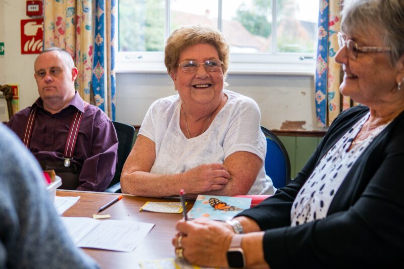 People sat at table smiling