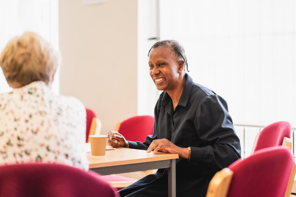 A man sitting at a table smiling