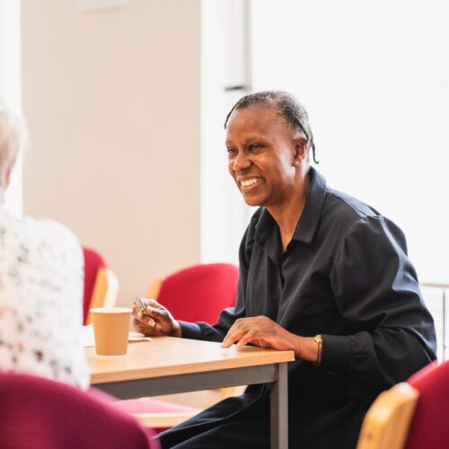 A man sitting at a table smiling