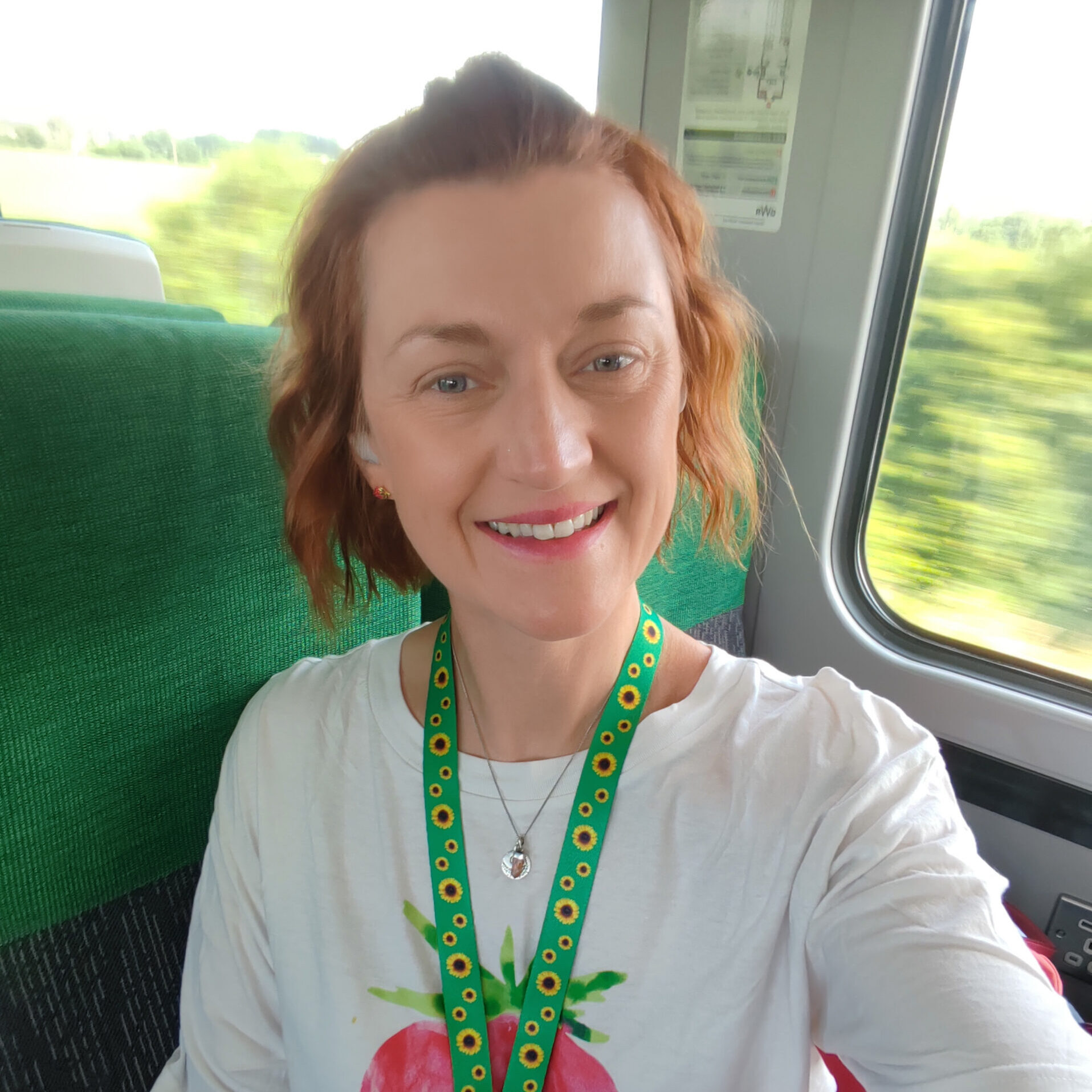 Samantha on a train with an invisible disabilities lanyard