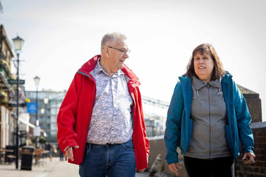 Picture of two people walking down street