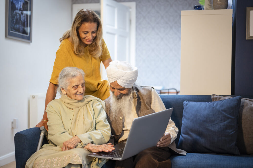 People sat on sofa on laptop