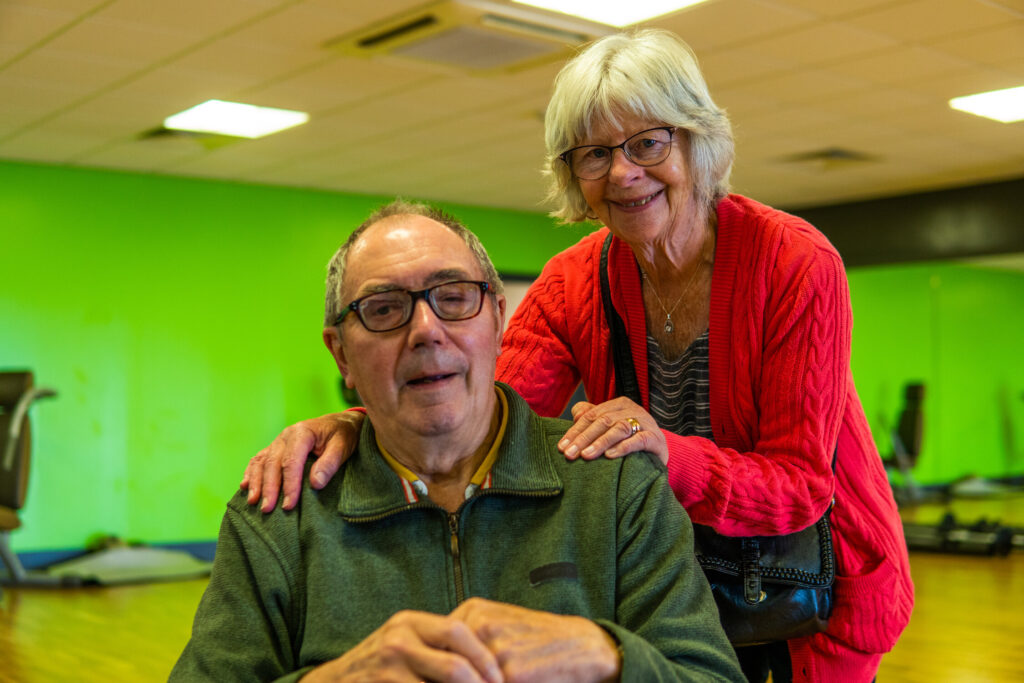 Woman with hands on man's shoulders