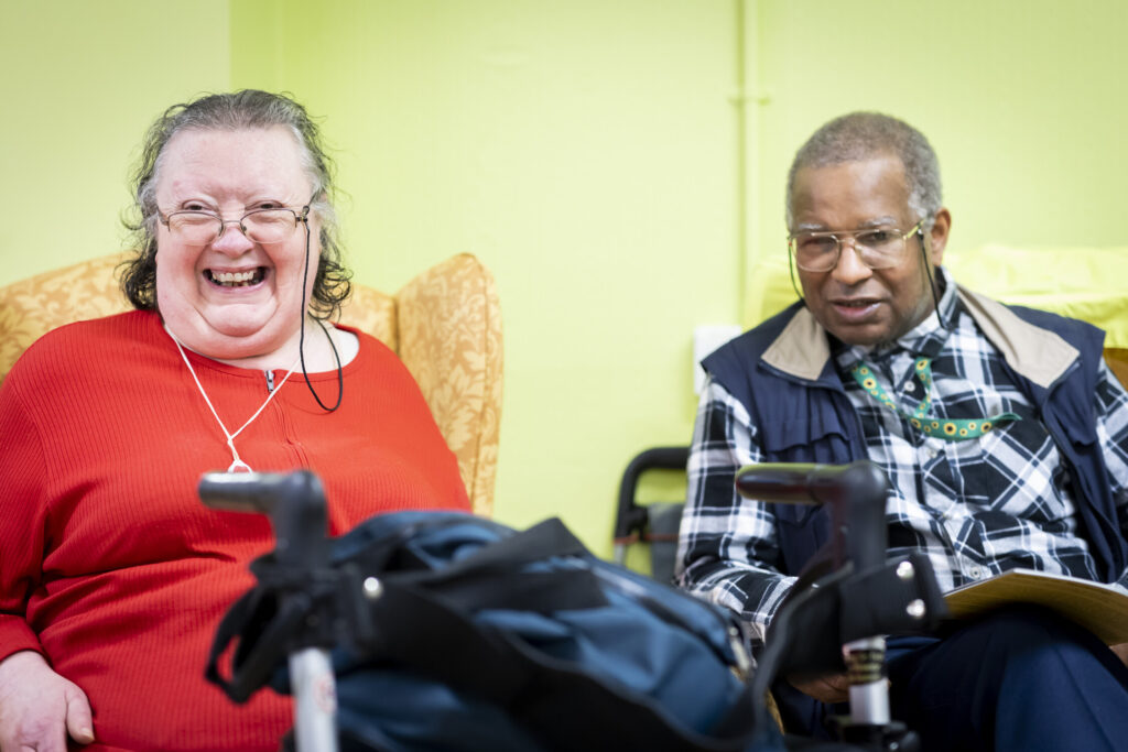 Lady laughing and man sat next to her