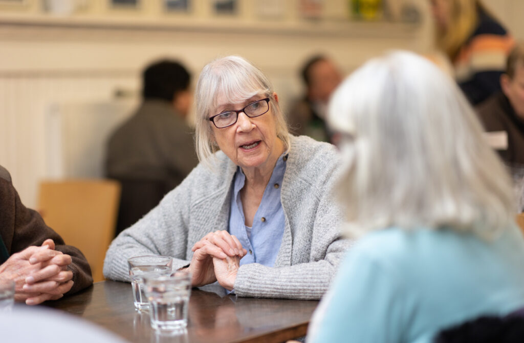 Women sat chatting at table