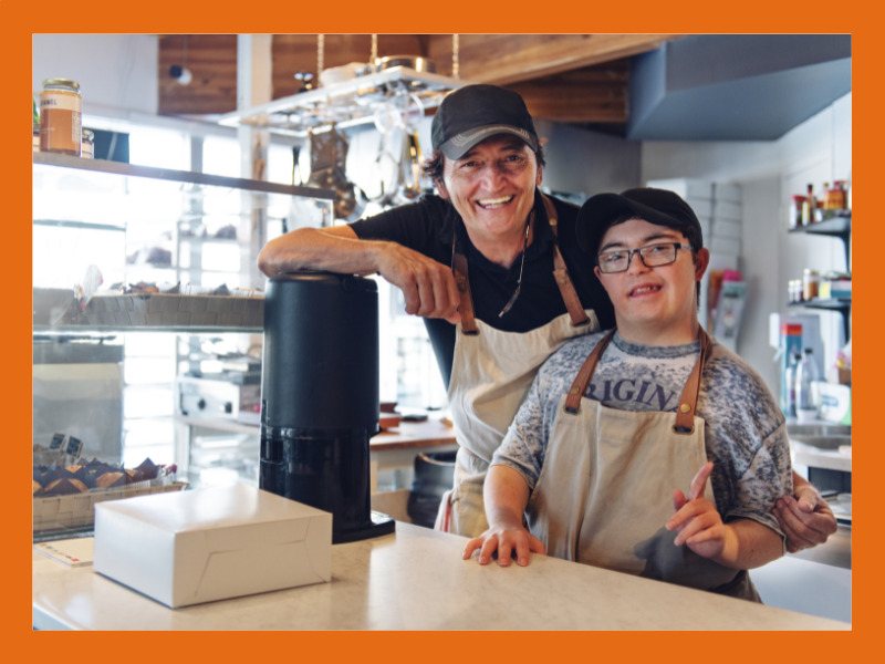 Two people at a cafe counter