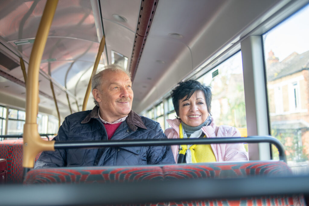A man and woman sitting together on a bus