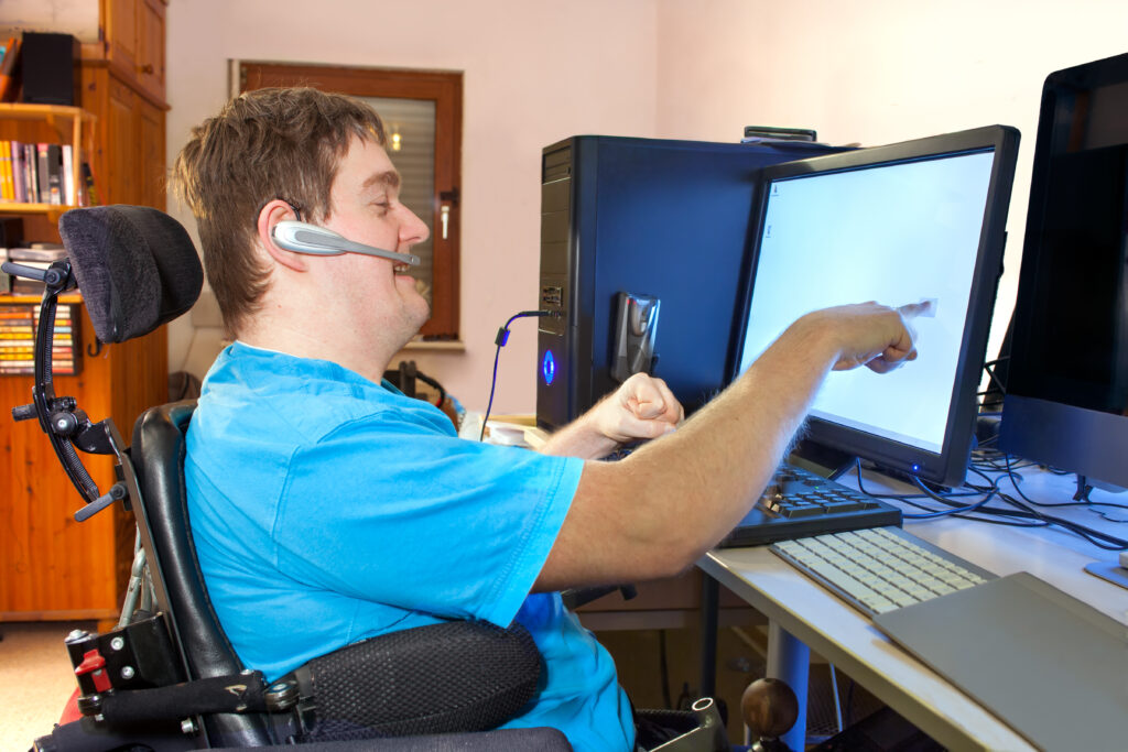 A young disabled man on a computer