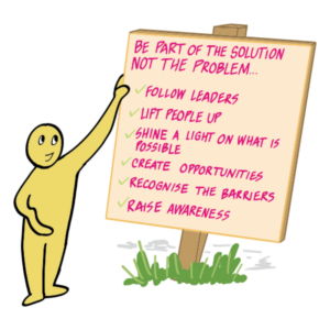 Person holding a sign that says "be part of the solution not the problem...- follow leaders - lift people up - shine a light on what is possible - create opportunities - recognise the barriers - raise awareness