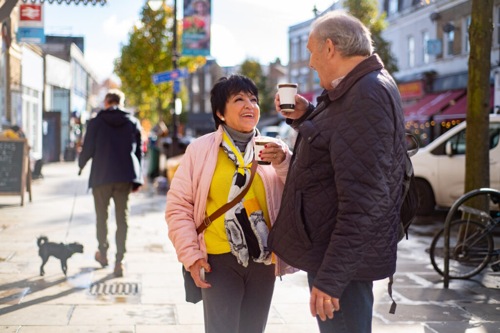 A man and a woman chatting on the street