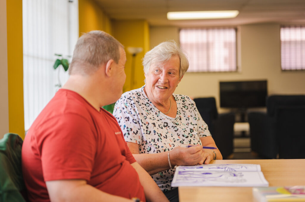 A man and a woman sitting at a table chatting