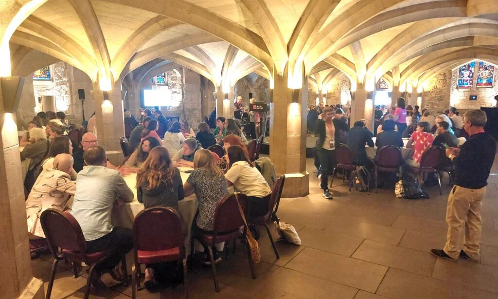 People sitting at tables in a conference room