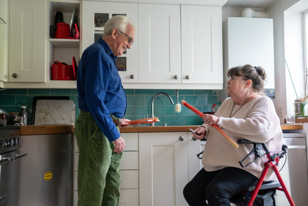 Two people chatting in a kitchen