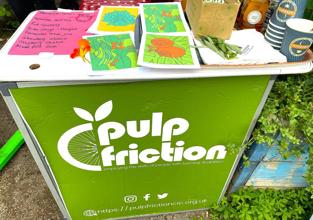 Pulp Friction branded table with leaflets on top