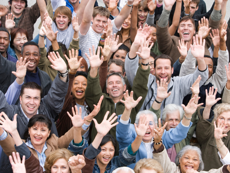 Large group of people waving at the camera