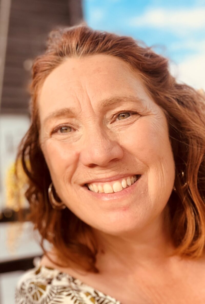 Profile image of a smiling woman.