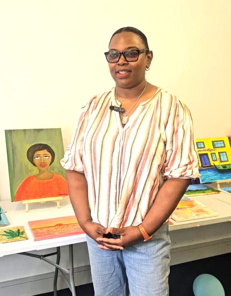 Person standing beside a portrait