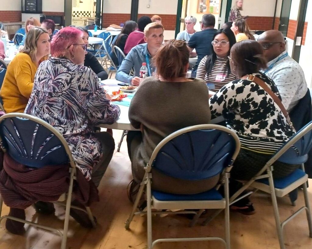 A group of people chatting around a table.