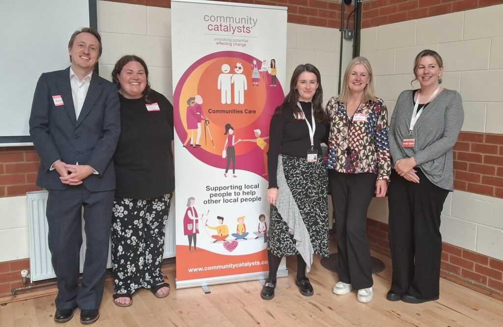 Five people from Community Catalysts standing and smiling at the camera.