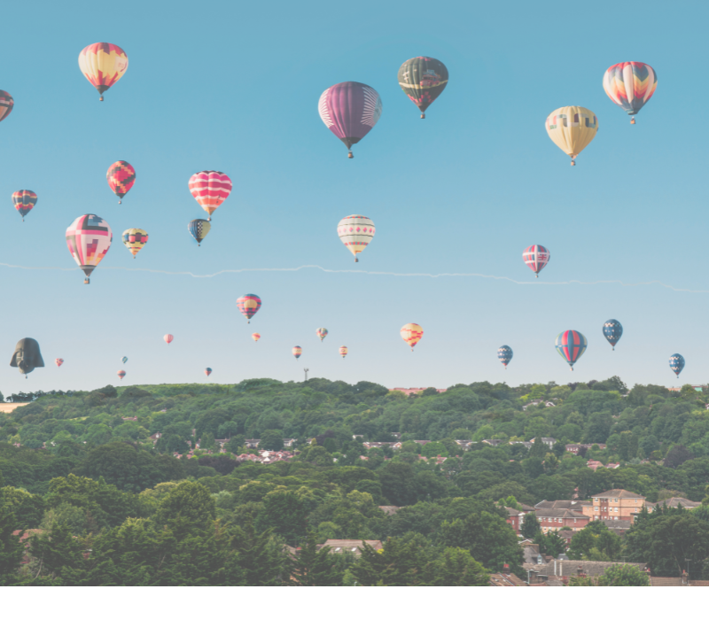 A group of colourful air balloons in the sky.