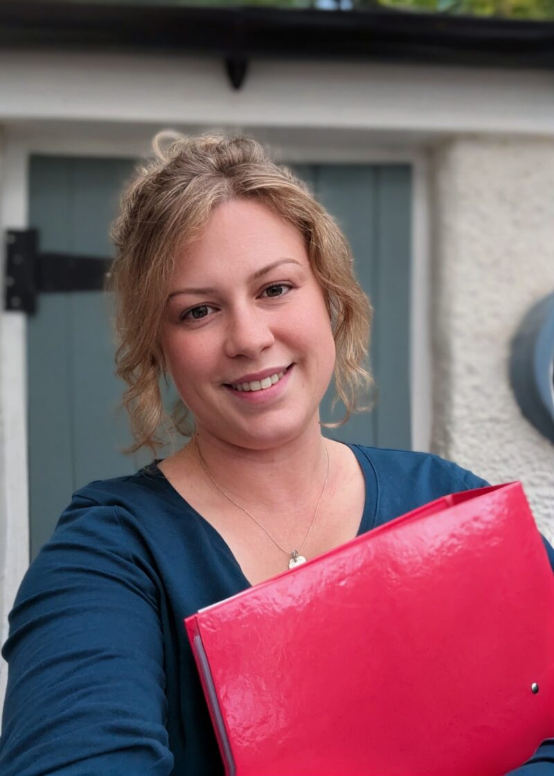 A woman holding a folder.
