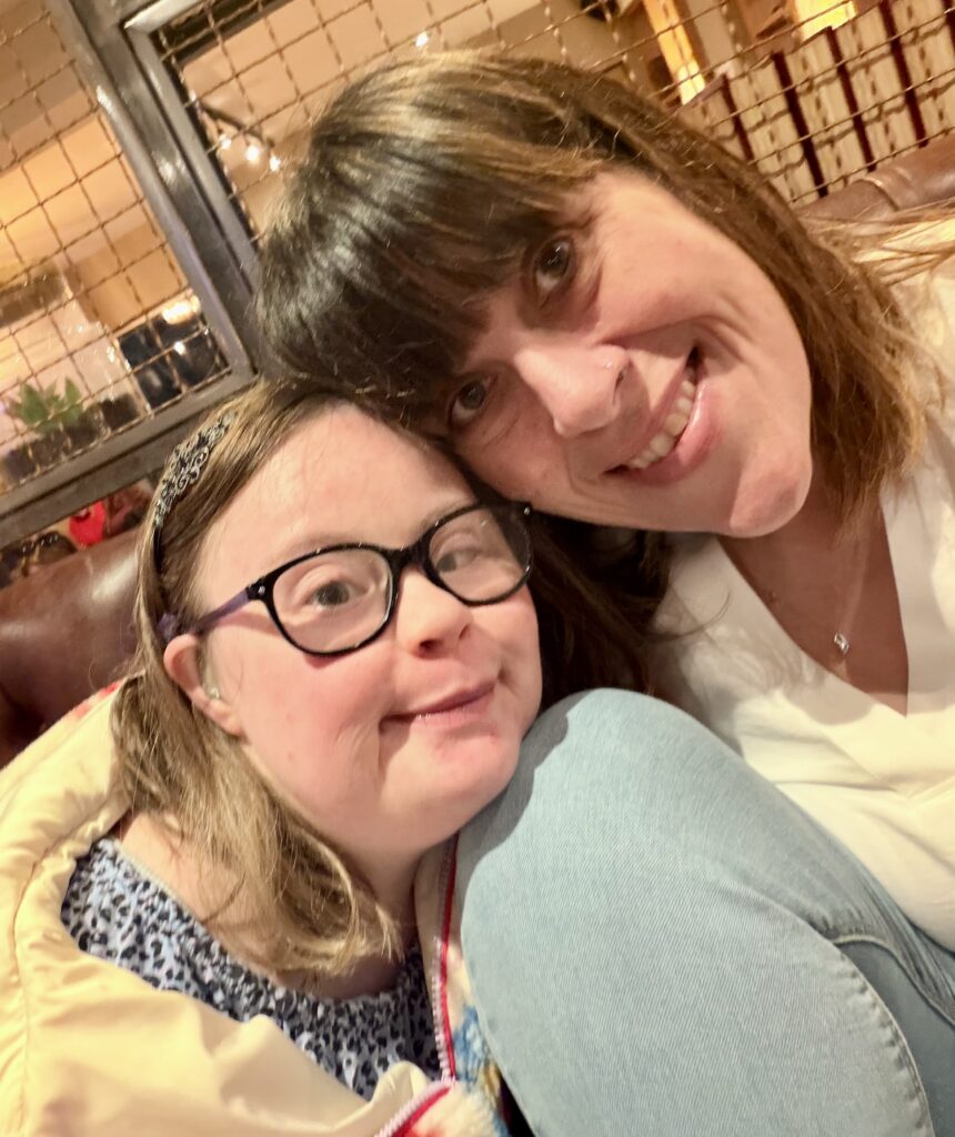 Two women smiling at the camera.