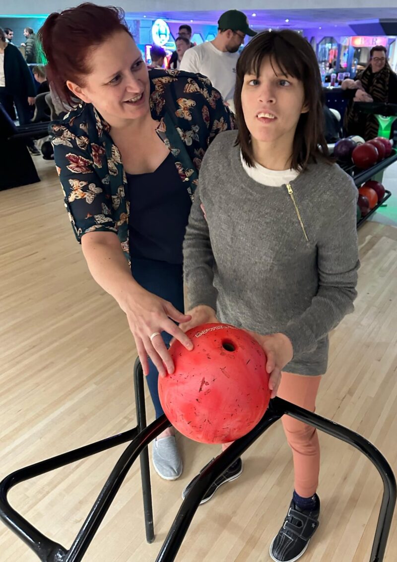 A woman supporting a person to take part in a sport