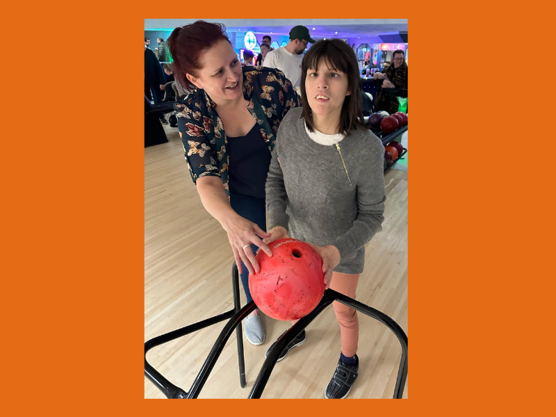 A woman supporting a person to take part in a sport