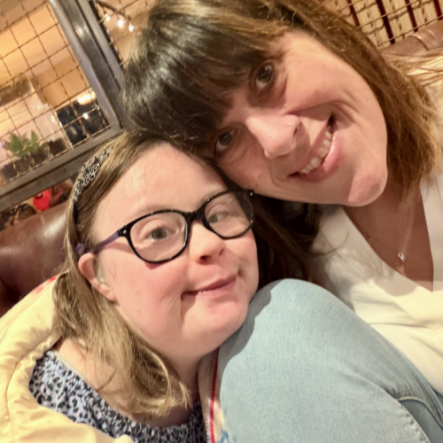 Two women smiling at the camera.