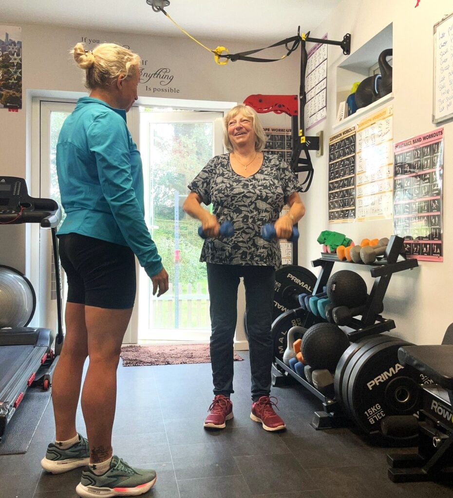 Two women standing in a gym
