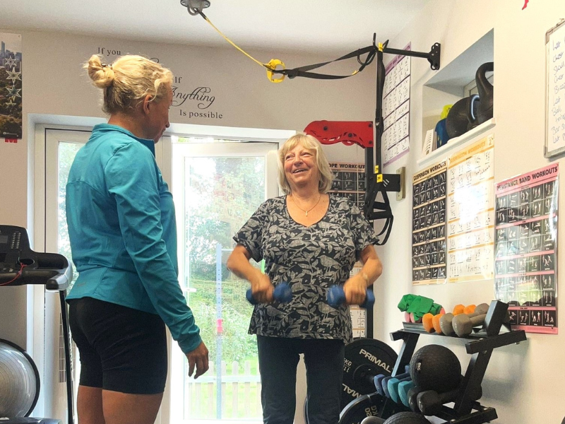 Two women standing in a gym