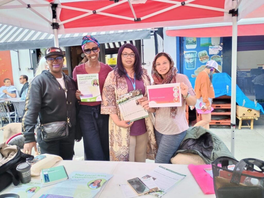 Four women standing at a stall