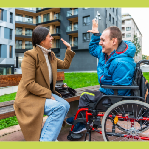 Two people sitting and high fiving each other
