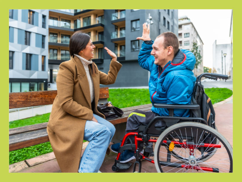 Two people sitting and high fiving each other