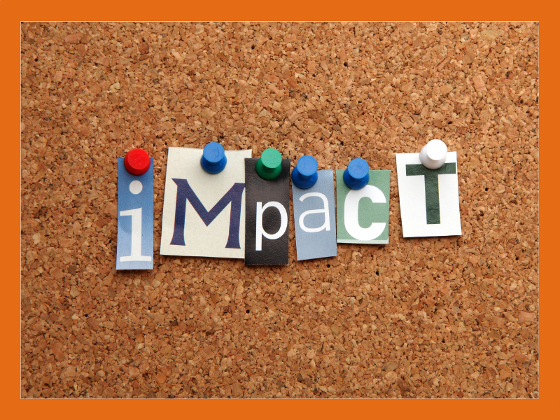 The word 'impact' on a cork board background